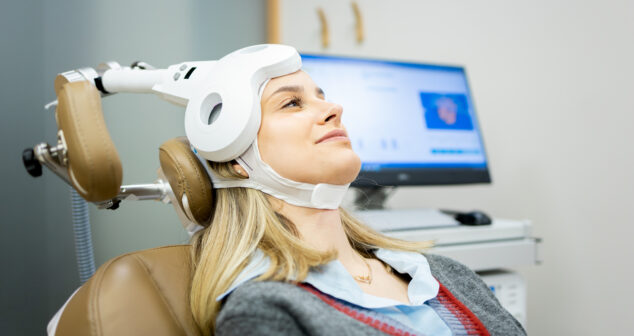 A Caucasian girl in her 20s or 30s undergoes transcranial magnetic stimulation therapy at a psychiatric facility to treat depression or anxiety.
