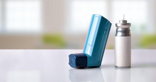 Cartridge and blue medicine inhaler in a room front view