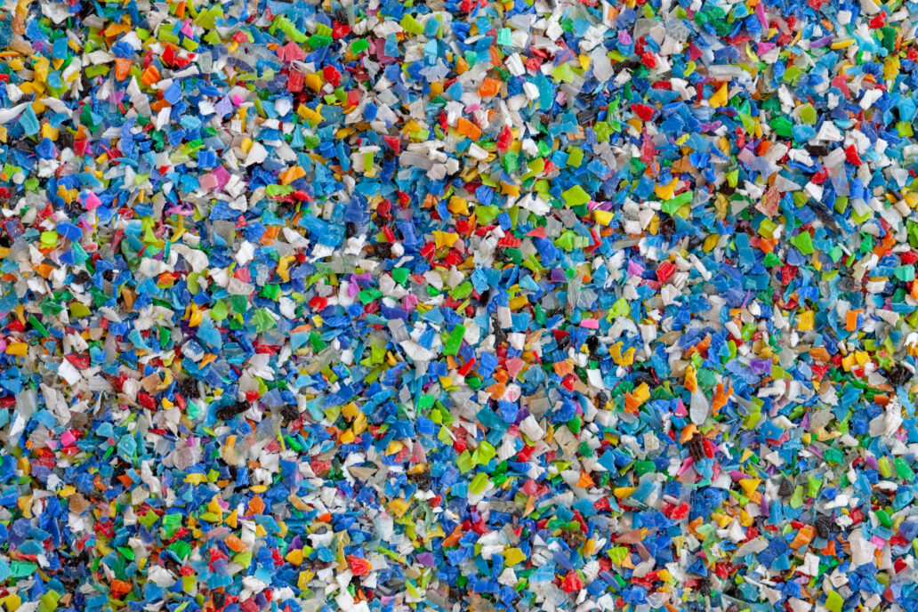 Crushed plastic granules for recycling. Plastic crusher. Recycled plastic with mixed colors. The concept of recycled plastic used
