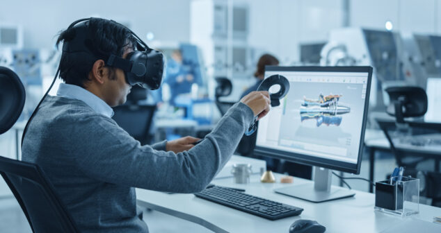 Medical Device Industrial Design Accessibility: Man with goggles looking at a computer screen while holding a circular device in his hand