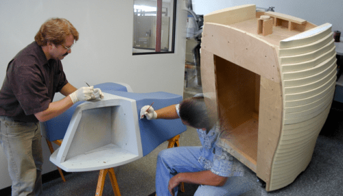 Wooden outer shell mock-up of the Gamma Medica imaging system showing early external skin engineering and CNC-routed components.