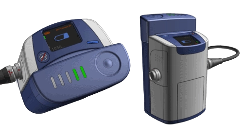 Rendered LVAD pump controllers showing interface screen, tactile buttons, and color-coded indicators in a compact handheld housing.