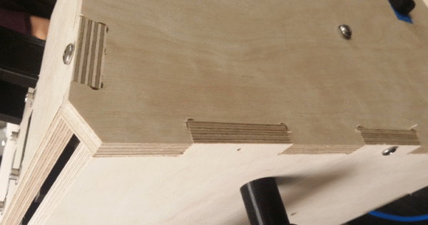 prototype medical device Description: closeup of wooden prototype showing edges and joints.