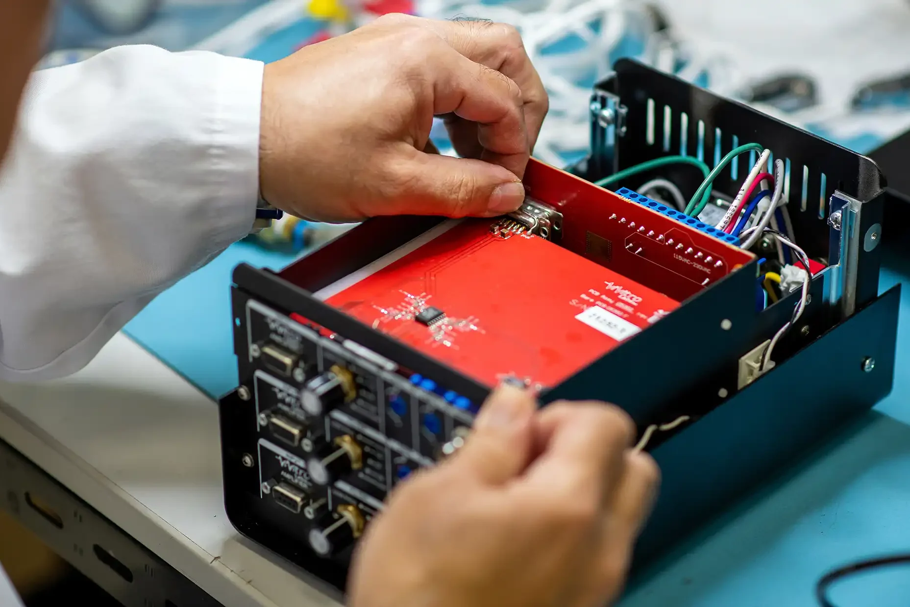 Engineer assembling a medical device circuit board during product development