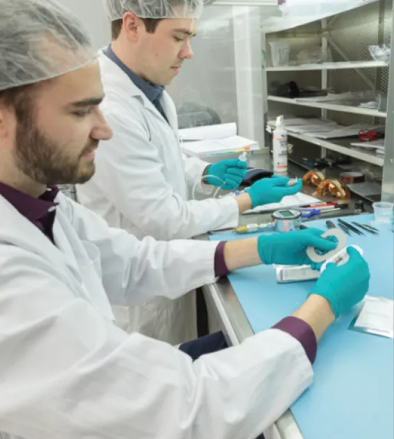 Technicians assembling ingestible capsules inside the StarFish Medical clean room
